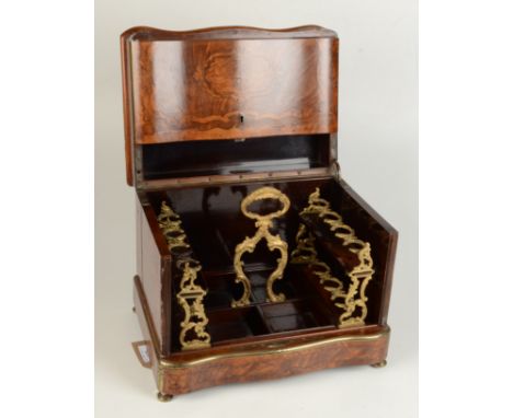 A Victorian burr walnut decanter box, the serpentine brass bound lift up hinged top enclosing a gilt metal and rosewood fitte