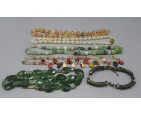 A Chinese silver mounted jade bracelet and jade and other necklaces.