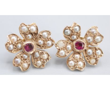 A pair of pearl and ruby gold flower head earrings.