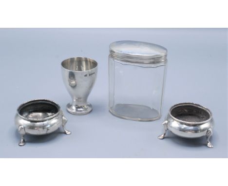 An egg cup by William H. Haseler, Birmingham 1935, a cut glass toilet jar with silver lid and a pair of Victorian open salts.