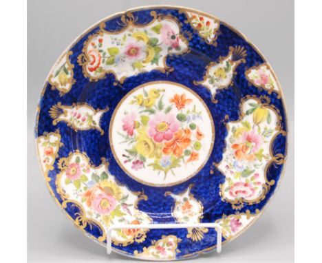 A Chamberlains Worcester porcelain cabinet plate, 19th century, painted with floral sprays within gilt cartouches, on a blue 