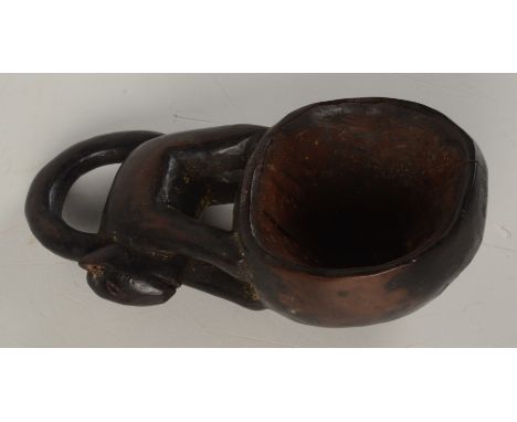 An African, Cameroon, Grassland tribal ceremonial spoon carved with a cat like creature, its tail forming the handle, length 