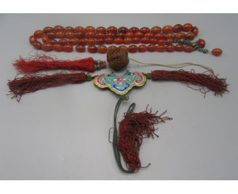An agate necklace, a Chinese enamel pendant together with a Chinese carved nut pendant.