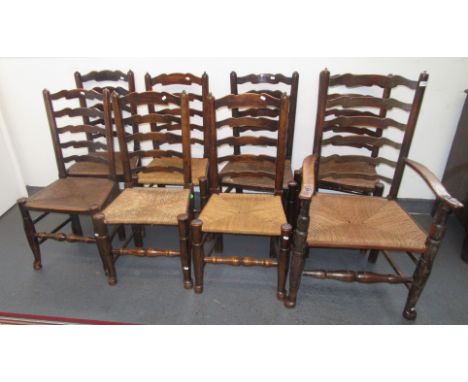 Eight various rush seated ladder back dining chairs including one armchair, early 19th century.