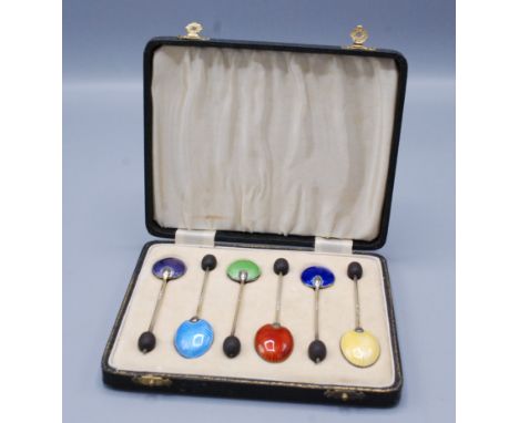 A set of six Harlequin enamelled bean finial toffee spoons, cased.