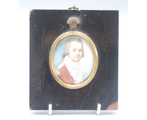 A 19th century portrait miniature of an Naval officer with padded wig and red coat in the manor of Cosway, gilt mounted frame