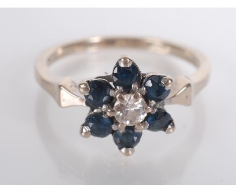 A sapphire and diamond flower head post war cluster ring. 