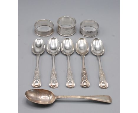 Five Victorian Kings pattern teaspoons and a beaded silver dessert spoon, together with three napkin rings, 5.9oz.