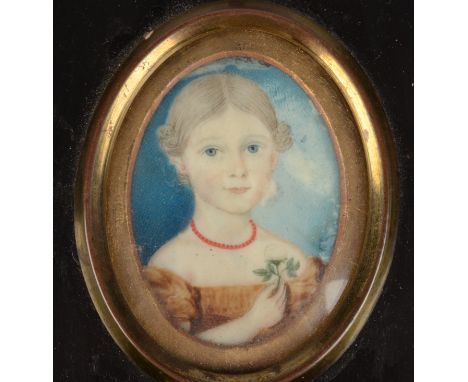 A George III English Provincial school portrait miniature of a girl, she holds a white rose. About her neck, a coral bead nec