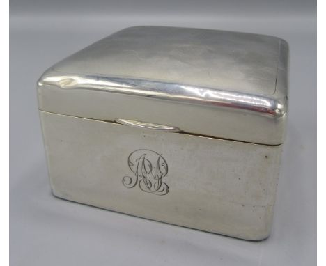 An engine turned silver cigarette box.