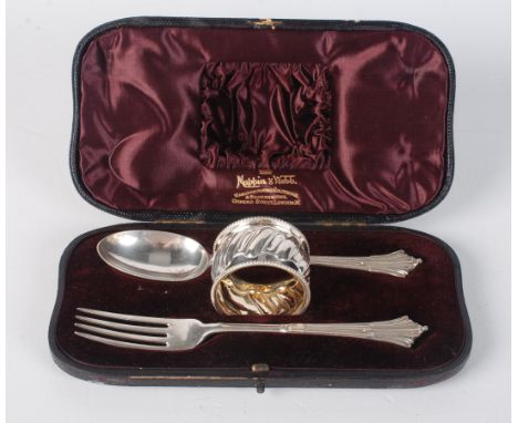 A 'Georgian' christening spoon and fork, London, 1894, cased, together with a beaded and fluted silver napkin ring, also Lond