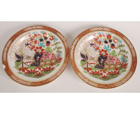 A pair of Worcester Flight Barr & Barr plates, early 19th century, decorated in the Imari style with a mock oriental garden s