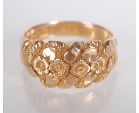 An Edwardian 18ct. gold ring chased with foliage and flower heads, Birmingham 1907, 6.3g.   Condition report:  Size - Q - Q 1