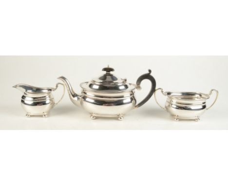 A pre-war silver three piece tea service in George III style, each of oval section with gadrooned rim on four feet, Birmingha