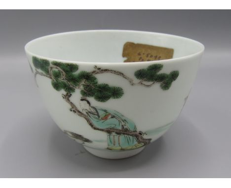 A Chinese famille verte teabowl decorated with figures and a goose beneath a fir tree, six character Kangxi mark to base, dia