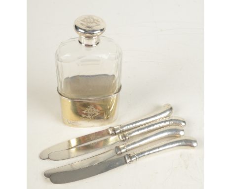 A spirit flask and four cake knives with filled silver handles.