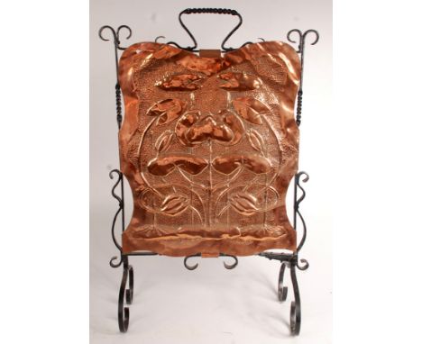 An Art Nouveau copper and wrought iron firescreen repousse decorated with lilies, height 78cm.