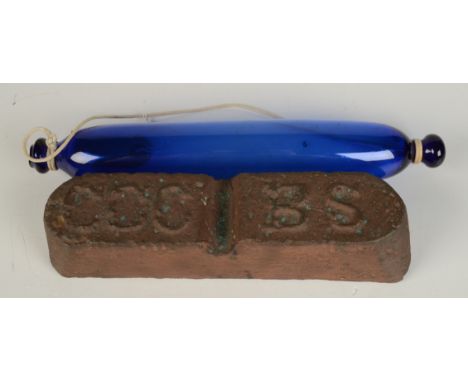 A Cornish Copper Company ingot, the top inscribed C.C.C.B.S., length 27cm, together with a Bristol blue glass rolling pin, le