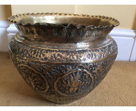 Eastern brass planter with foliate decoration and eastern figures