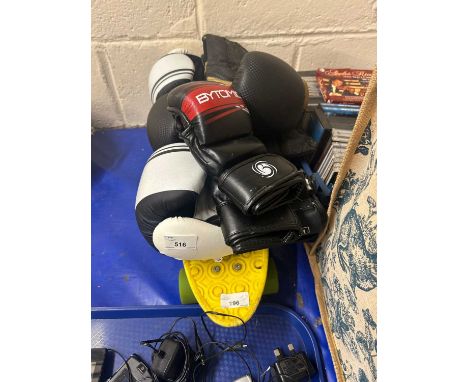 Three pairs of boxing gloves and a skateboard