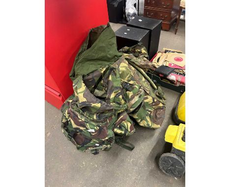 Two army backpacks with various accessories