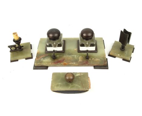 An art deco century onyx desk set with a desk stand, candle stick and matchbox stand and blotter 34cm wide