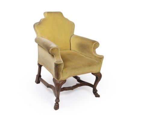 A Georgian style yellow upholstered armchair with cabriole legs and hoof feet, 66cm wide x 69cm deep x 89cm high at the backU
