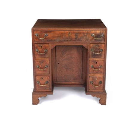 A George III mahogany kneehole desk with a caddy top, one long drawer and six small drawers, with brass swan neck handles, br