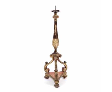 A late 18th or early 19th century Italian giltwood floor standing pricket candlestick with scrolling acanthus leaf decoration