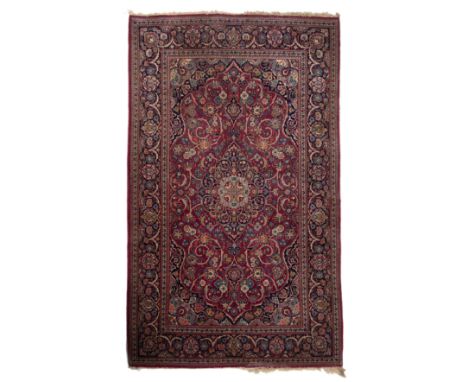 A 20th century Persian style hand knotted rug with a multiple banded border and foliate decoration, 136cm x 213cmTassles cut 