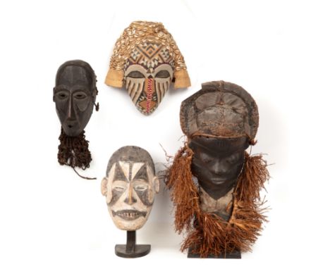 Four African tribal masks to include a Pende, A Kuba beaded mask with cowrie shells and an Igbo mask 15cm wide 21cm high (4)