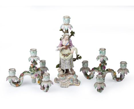 A late 19th/ early 20th century Meissen figural candlestick 38cm high and two four branches tops 25cm wide