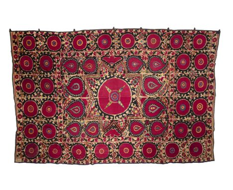 A Tajik suzani with large star medallion, silk embroidery on hand woven cotton. Mid to late 19th century 280cm x 186cmA few p