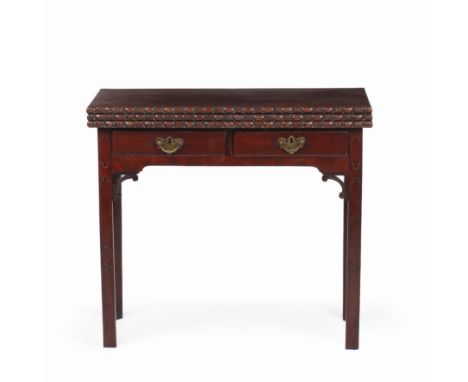 A George III mahogany tea and card table with a two fold top above two frieze drawers and square legs, with blind fretwork de