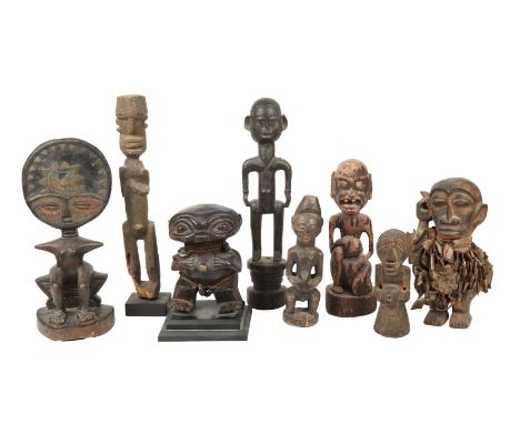 A collection of eight African tribal carved wood figures to include and Ashanti beaded figure 34cm high a Cameroon pygmy figu