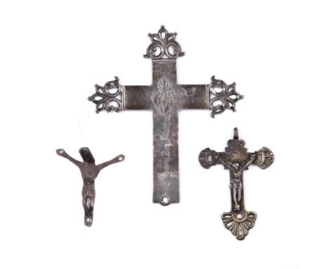 A white metal crucifix 14cm wide 17cm high together with two small antique corpus christi (3) Provenance: Alan Winston (1930-