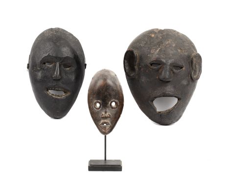 A small antique African Dan mask 9cm wide 16cm high and two primitive masks (3)