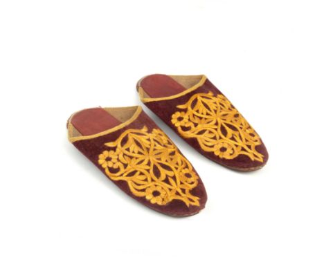 A pair of velvet and silk embroidered slippers the leather soles 24cm in length.Once the property of T.E Lawrence by repute, 
