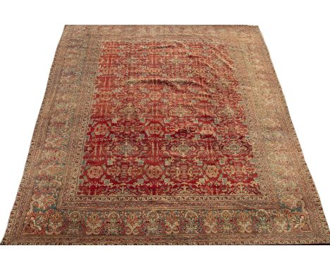 An antique Agra carpet with a banded border and stylised motifs 362cm x 275cmReduced on one side
