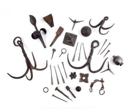 A collection of antique iron work to include two 19th century iron fruit ornaments a 19th century American civil war caltrop 