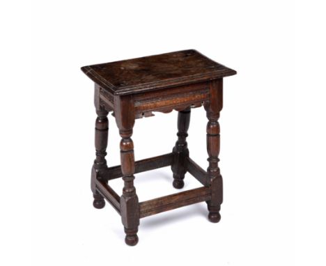 A 17th/18th century oak joint stool with turned supports 47cm wide 33cm deep 58cm highAreas of woodworm, top with surface scr