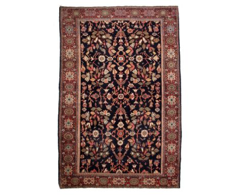 A Persian blue and red ground rug with a banded border and foliate decoration 134cm x 203cm Provenance: From an east Oxfordsh
