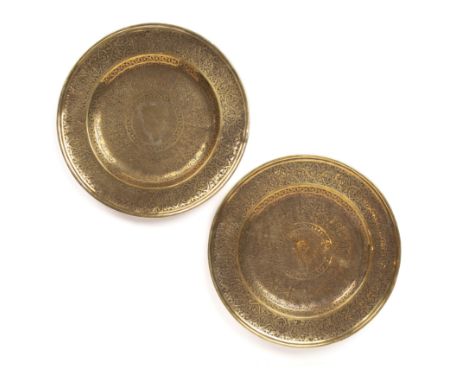 A pair of 16th century Vento Saracernic gilt metal chargers, each engraved with the blazen of an Italian noble family with la