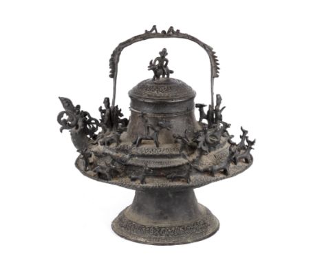 A large 19th century Malay bronze ritual kettle and cover of flattened ovoid form applied with animals and figures 46cm wide 