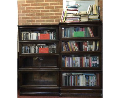  Two early 20th century oak Globe Wernicke four section bookcases, with glazed doors, the largest 86cm wide 29cm deep 156cm h