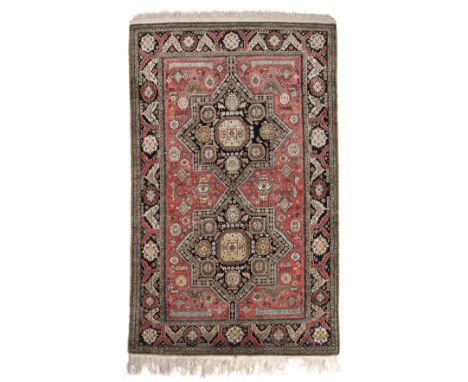 A 20th century Kashmiri silk rug with a banded border and geometric decoration 103cm x 175cm Provenance: From an east Oxfords