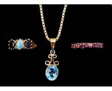 Gold blue topaz pendant necklace, gold three stone opal and sapphire ring and a five stone garnet, all 9ctCondition Report:St