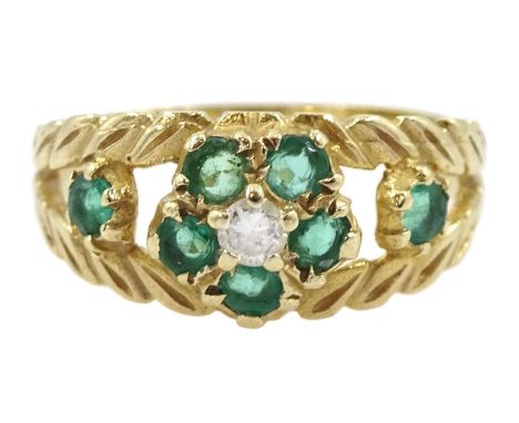 9ct gold emerald and diamond flower head cluster ring, with pierced leaf design emerald set shoulders, London 1976Condition R