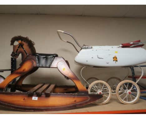 A vintage rocking horse and vintage pram 