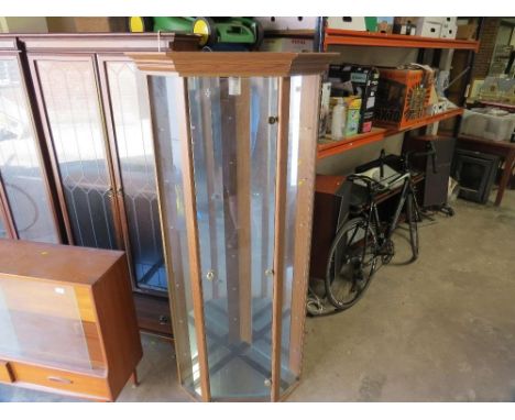A glazed corner display cabinet with glass shelves, mirrored back and light 